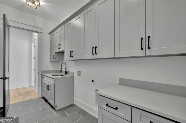 a kitchen with stainless steel appliances white cabinets and a sink