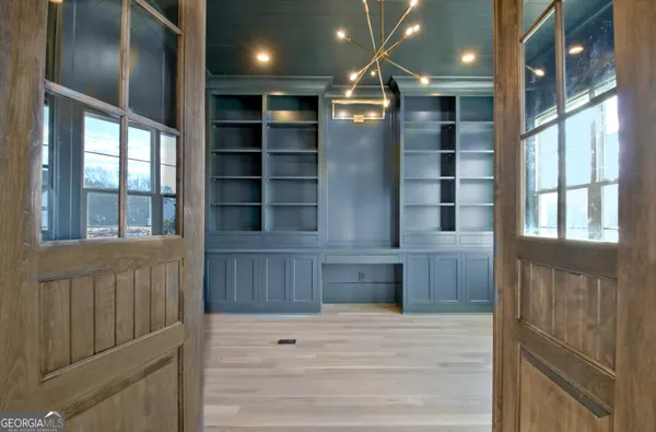 a view of kitchen with cabinets and window