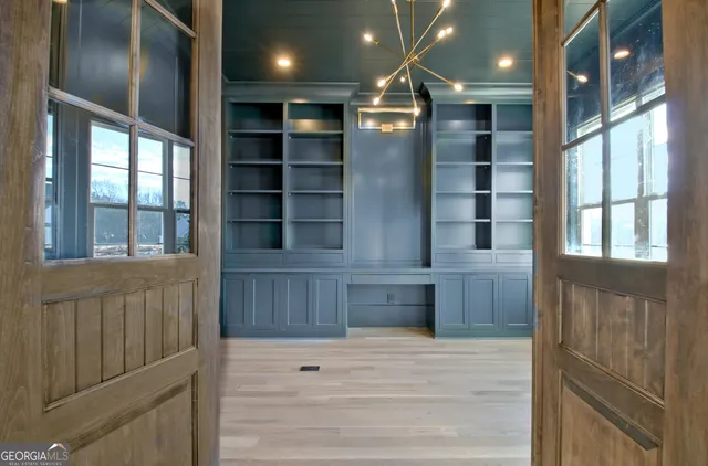 a view of kitchen with cabinets and window