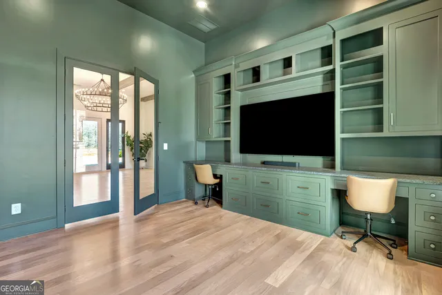 a room with a chair and a flat screen tv