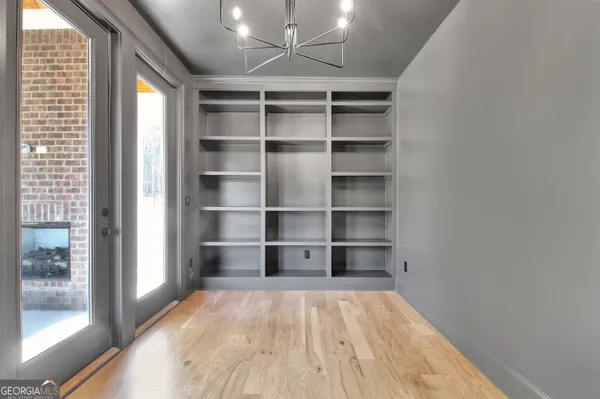 a view of a room with a wooden floor and windows