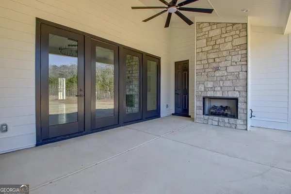 a view of an empty room with a fireplace and a window