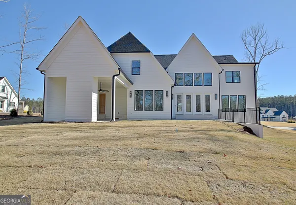 a view of an house with backyard and road