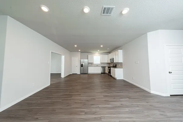 a view of kitchen with kitchen island and stainless steel appliances