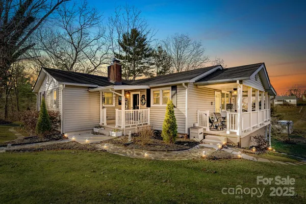 a backyard of a house with yard table and chairs