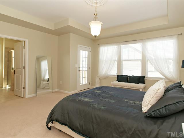 1403 Van Page Boulevard Raleigh, NC 27607 - Photo 15 of 25 The luxury master suite boasts a trey ceiling, triple window, and a huge walk-in closet. Master Suite