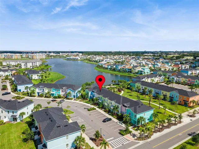an aerial view of residential houses with outdoor space and ocean view