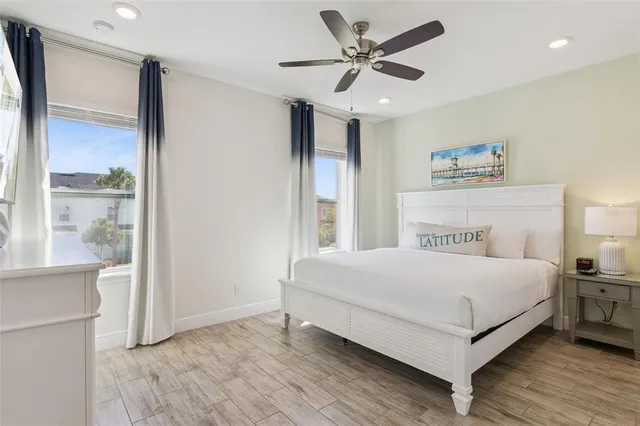 a spacious bedroom with a bed and a cabinets