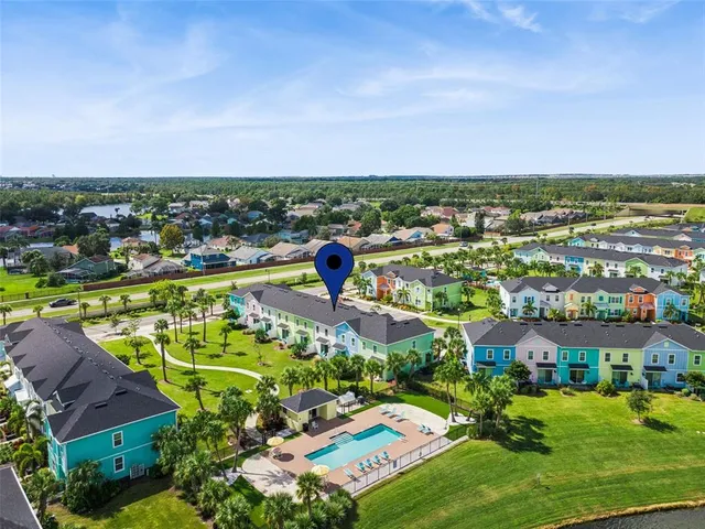 an aerial view of a houses with a city view