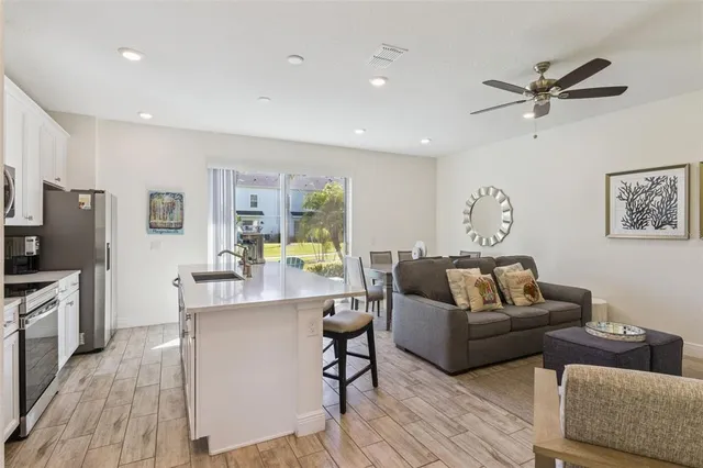 a living room with furniture kitchen view and a fireplace