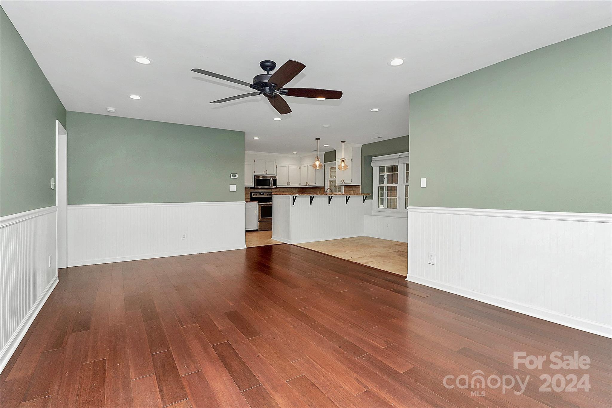 623 Trail Ridge Road Matthews, NC 28105 - Photo 11 of 38 a view of a kitchen with a dishwasher and wooden floor