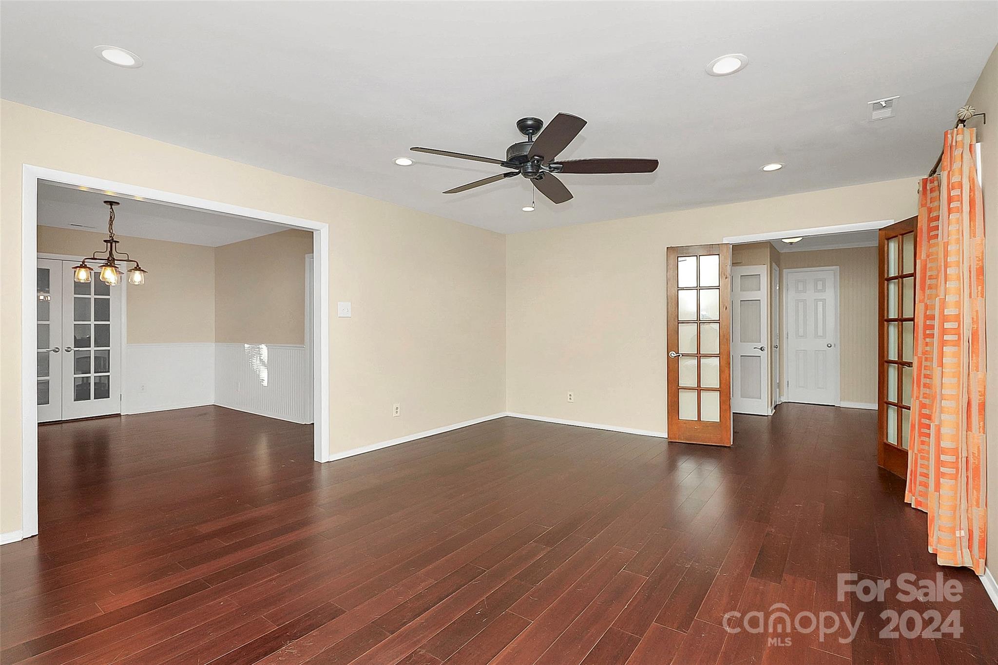 623 Trail Ridge Road Matthews, NC 28105 - Photo 14 of 38 a view of an empty room with wooden floor and a window