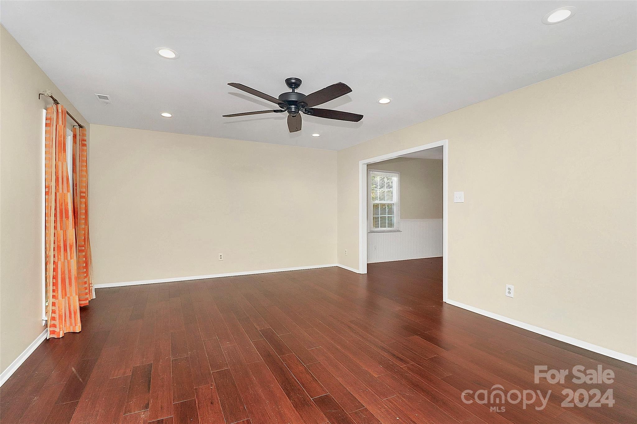 623 Trail Ridge Road Matthews, NC 28105 - Photo 15 of 38 a view of an empty room with a window and wooden floor