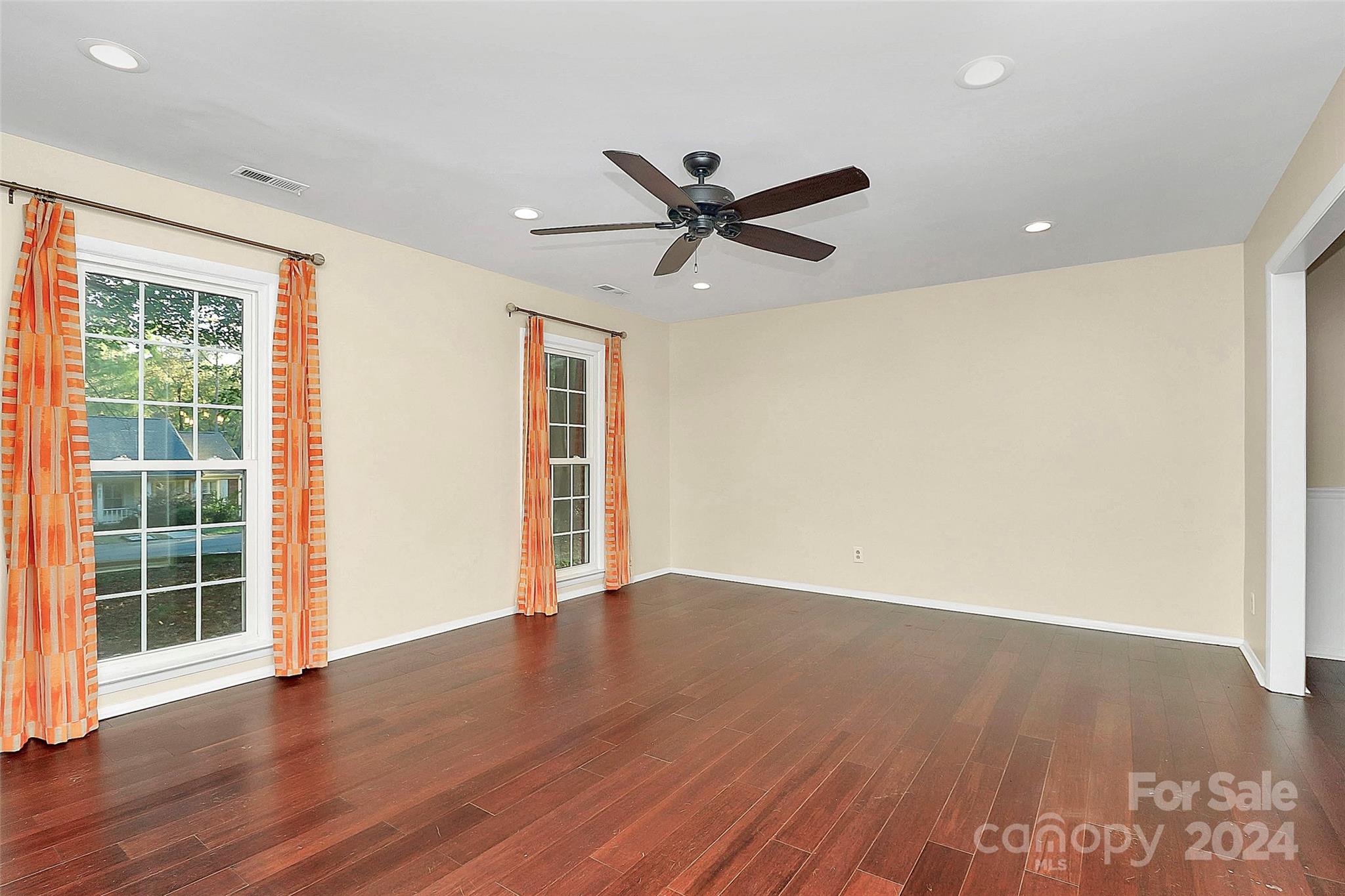 623 Trail Ridge Road Matthews, NC 28105 - Photo 16 of 38 an empty room with wooden floor and windows