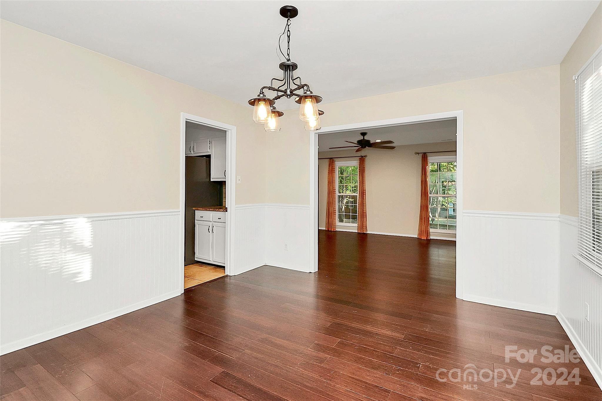 623 Trail Ridge Road Matthews, NC 28105 - Photo 18 of 38 a view of an empty room with wooden floor and a window