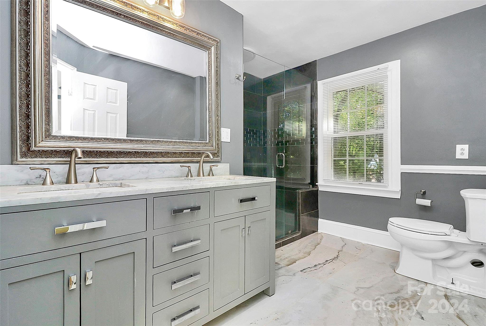 623 Trail Ridge Road Matthews, NC 28105 - Photo 20 of 38 a spacious bathroom with a double vanity sink mirror and toilet