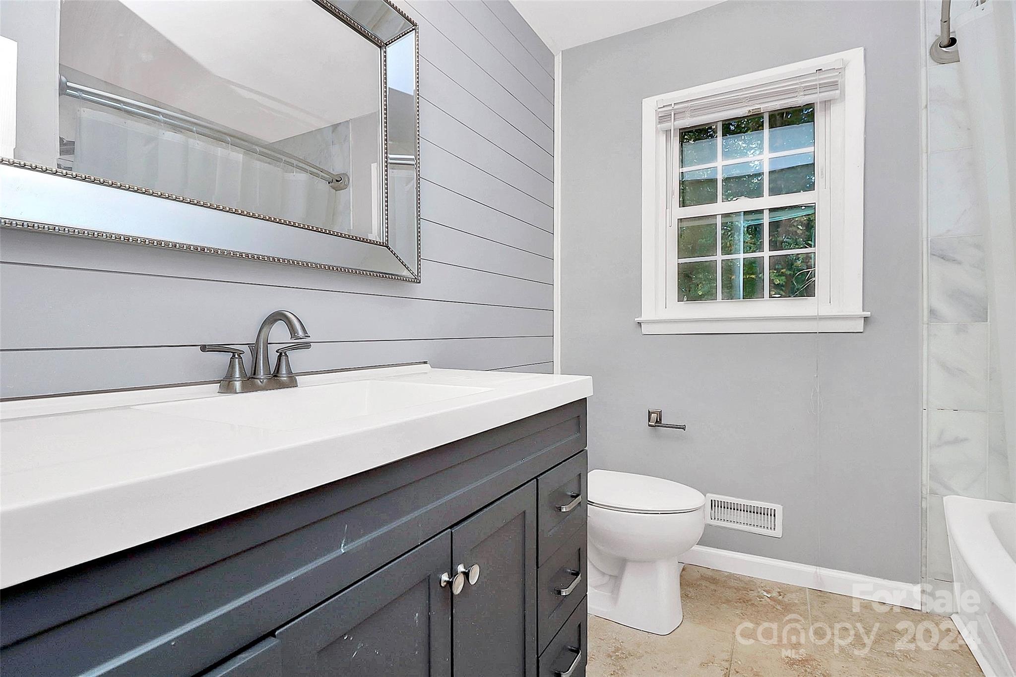 623 Trail Ridge Road Matthews, NC 28105 - Photo 22 of 38 a bathroom with a sink a toilet and a window