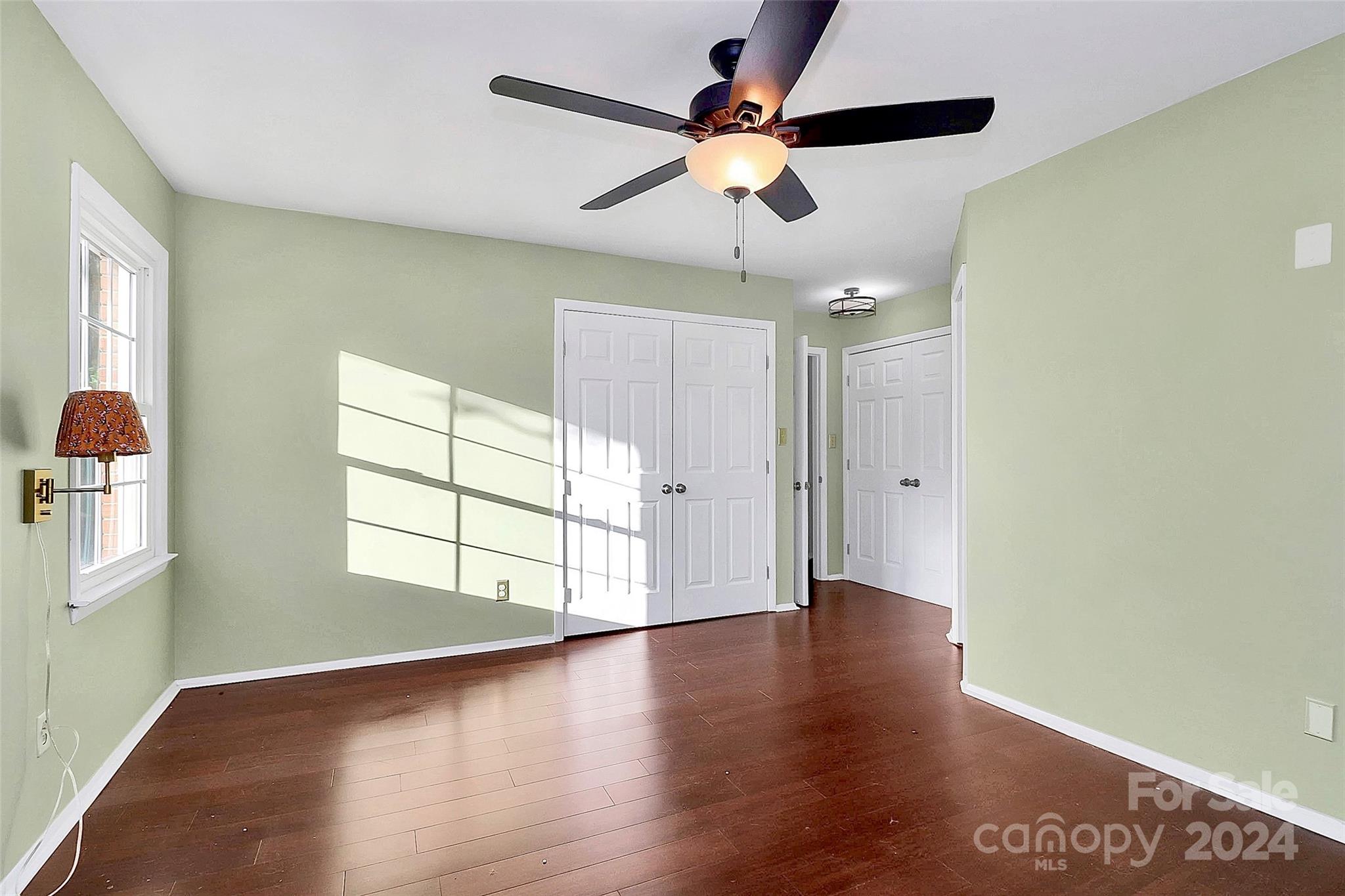 623 Trail Ridge Road Matthews, NC 28105 - Photo 24 of 38 a view of an empty room with a window and wooden floor