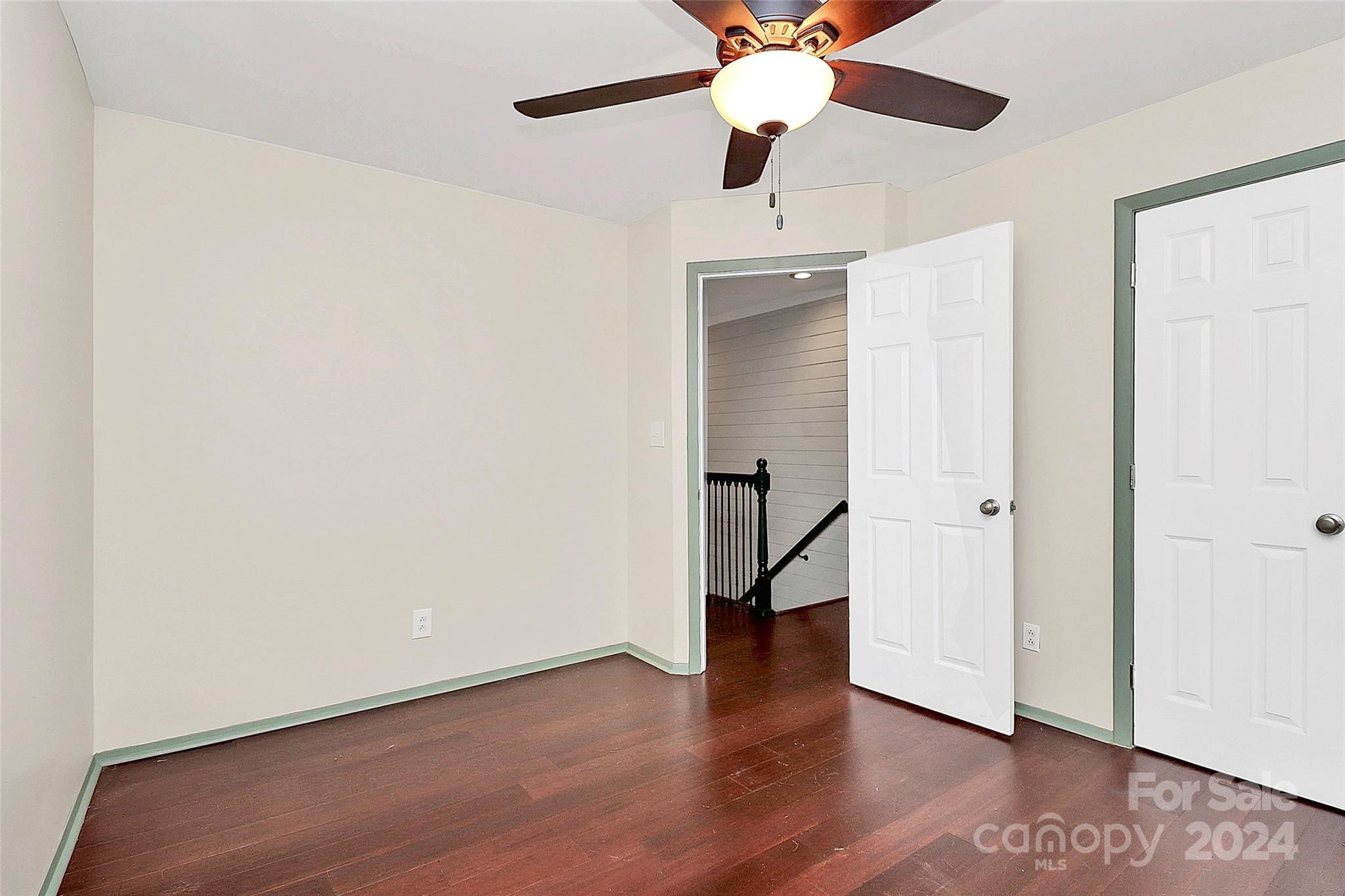 623 Trail Ridge Road Matthews, NC 28105 - Photo 30 of 38 an empty room with wooden floor a ceiling fan and carpet