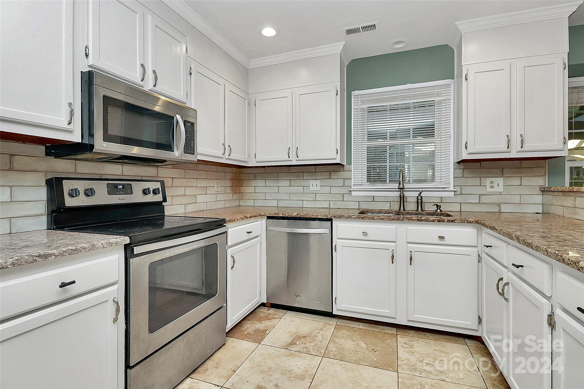 623 Trail Ridge Road Matthews, NC 28105 - Photo 6 of 38 a kitchen with granite countertop white cabinets stainless steel appliances and a sink