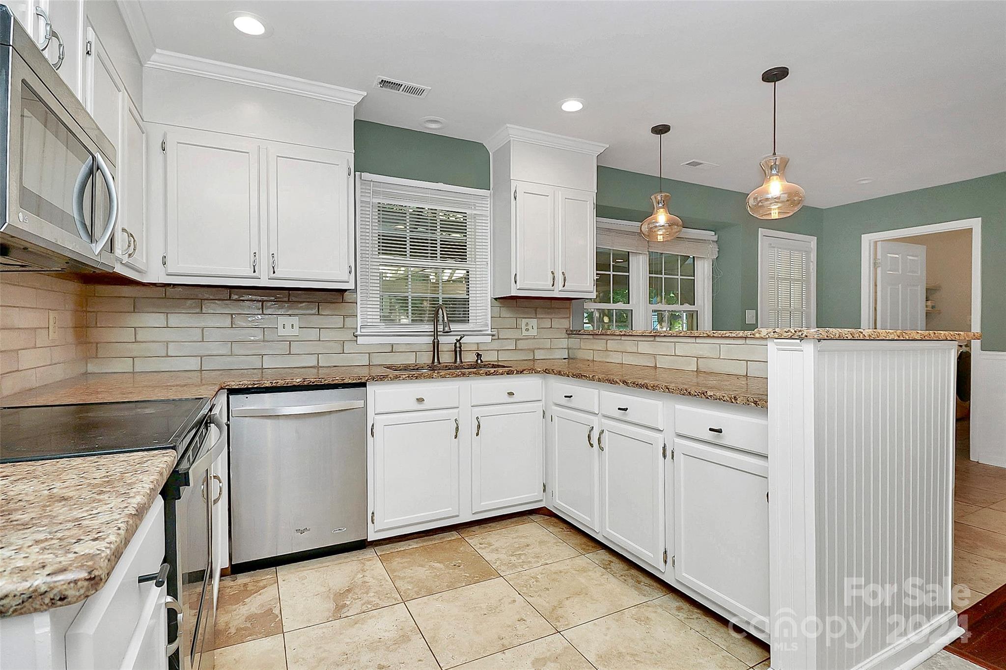 623 Trail Ridge Road Matthews, NC 28105 - Photo 7 of 38 a kitchen with granite countertop cabinets stainless steel appliances a sink and a counter top space
