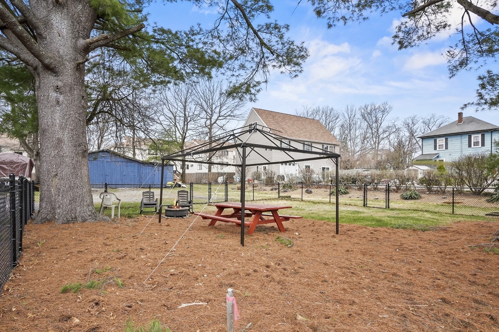 7 Rural Street Worcester, MA 01604 - Photo 2 of 5 a backyard of a house with table and chairs