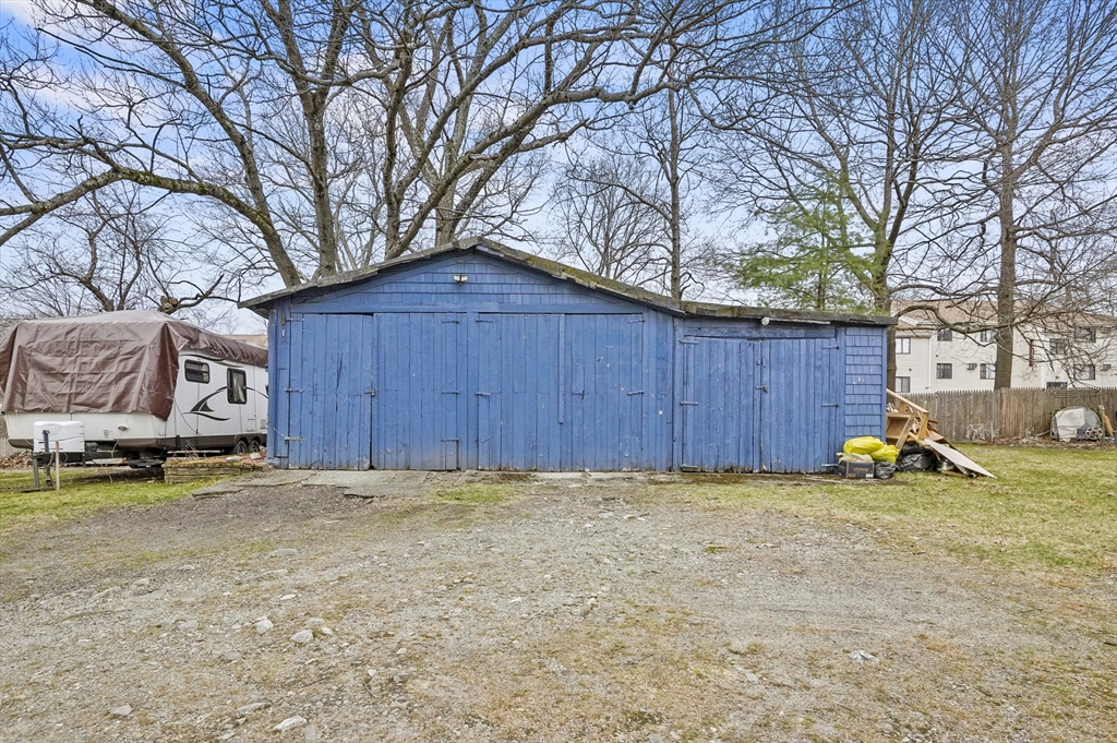 7 Rural Street Worcester, MA 01604 - Photo 4 of 5 a view of a backyard with a large tree and wooden fence