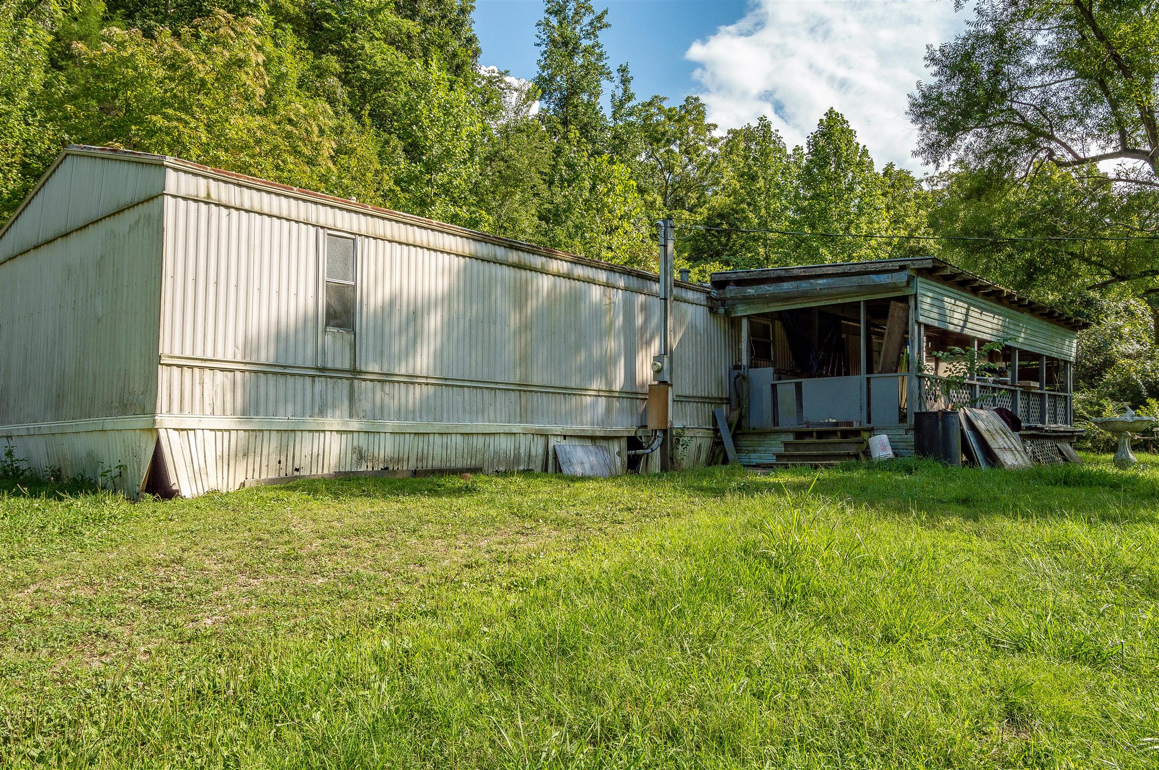 2233 Peach Road Minor Hill, TN 38473 - Photo 12 of 30 a backyard of a house with table and chairs