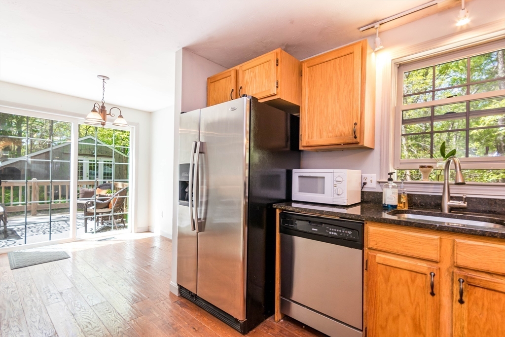 848 Cotuit Road Mashpee, MA 02649 - Photo 12 of 28 a kitchen with stainless steel appliances granite countertop a refrigerator and a sink