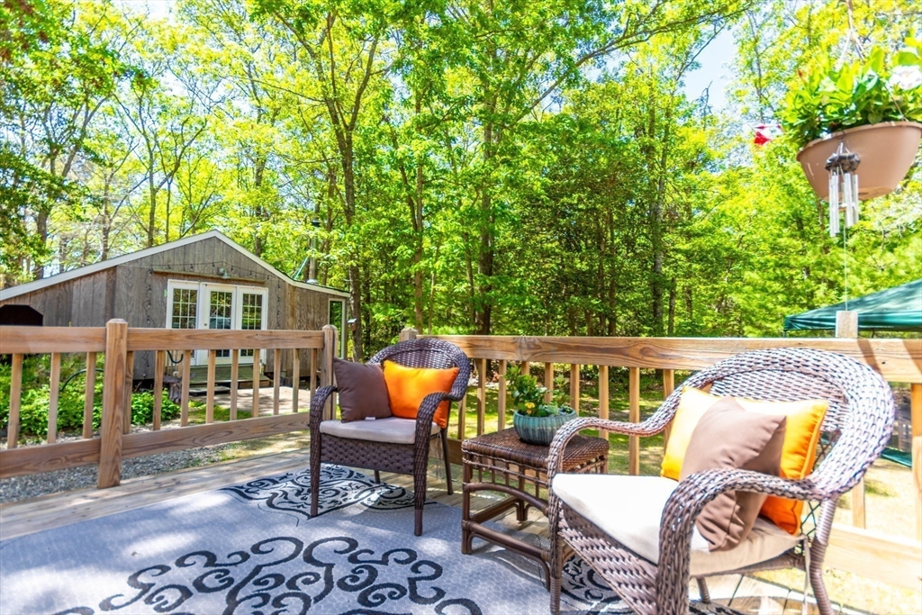 848 Cotuit Road Mashpee, MA 02649 - Photo 4 of 28 a roof deck with table and chairs and potted plants