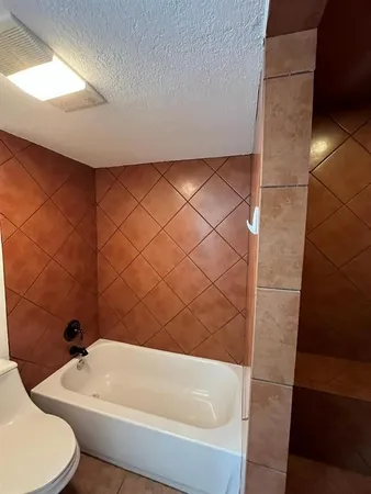 a bathroom with a shower and toilet