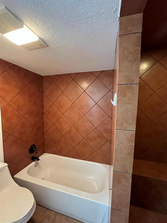 640 Harbor Drive Azle, TX 76020 - Photo 11 of 33 a bathroom with a bathtub and shower