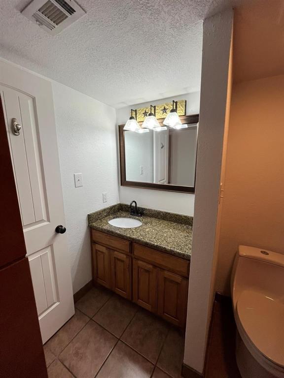 640 Harbor Drive Azle, TX 76020 - Photo 13 of 33 a bathroom with a granite countertop sink and mirror with toilet