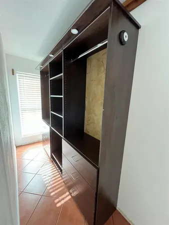a view of a closet with wooden floor