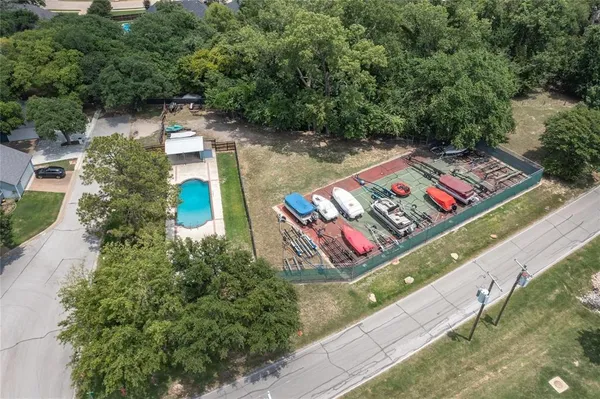 an aerial view of a house with outdoor space and lake view in back