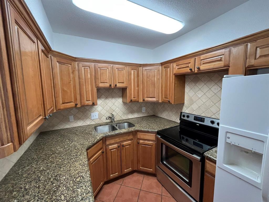 640 Harbor Drive Azle, TX 76020 - Photo 10 of 33 a kitchen with granite countertop a stove and a sink