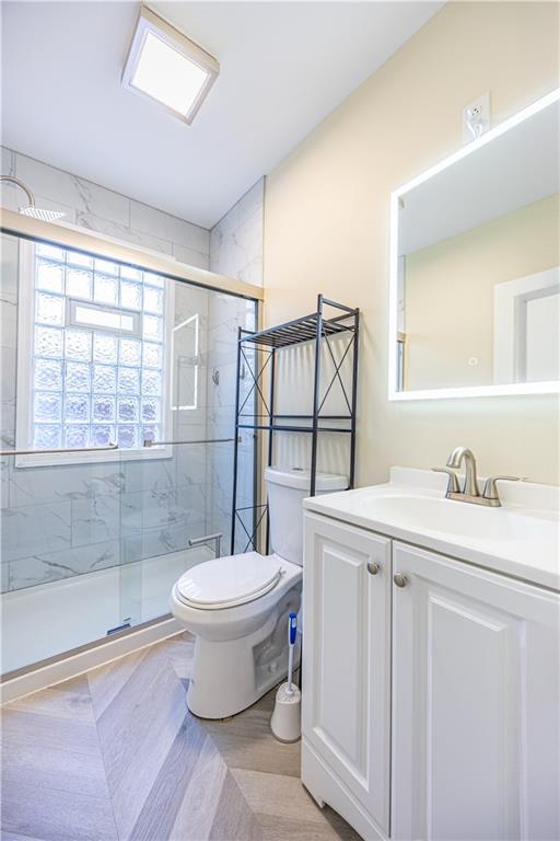 1727 Morningside Avenue Pittsburgh, PA 15206 - Photo 14 of 16 a bathroom with a granite countertop sink toilet a mirror and shower