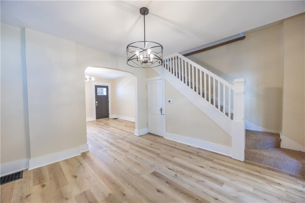 1727 Morningside Avenue Pittsburgh, PA 15206 - Photo 6 of 16 a view of a hallway with wooden floor and staircase