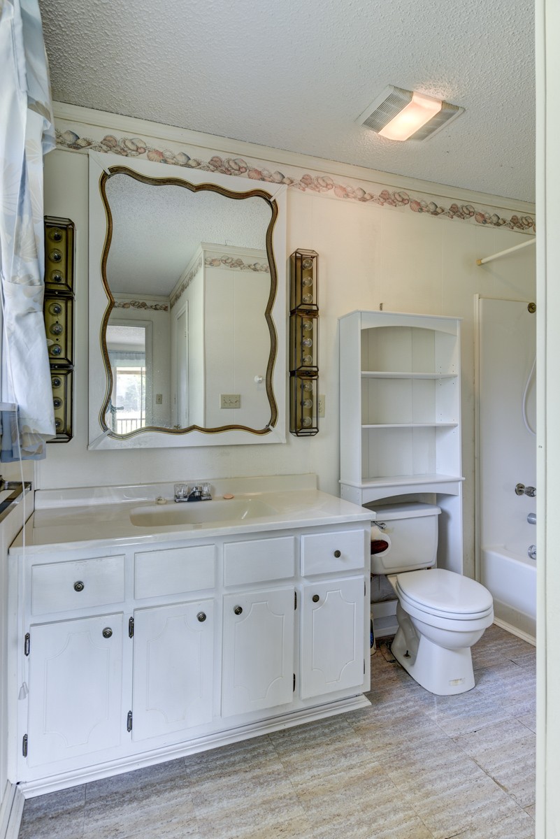 3945 Mitchell Road Lebanon, TN 37087 - Photo 26 of 41 a bathroom with a granite countertop sink mirror vanity and toilet