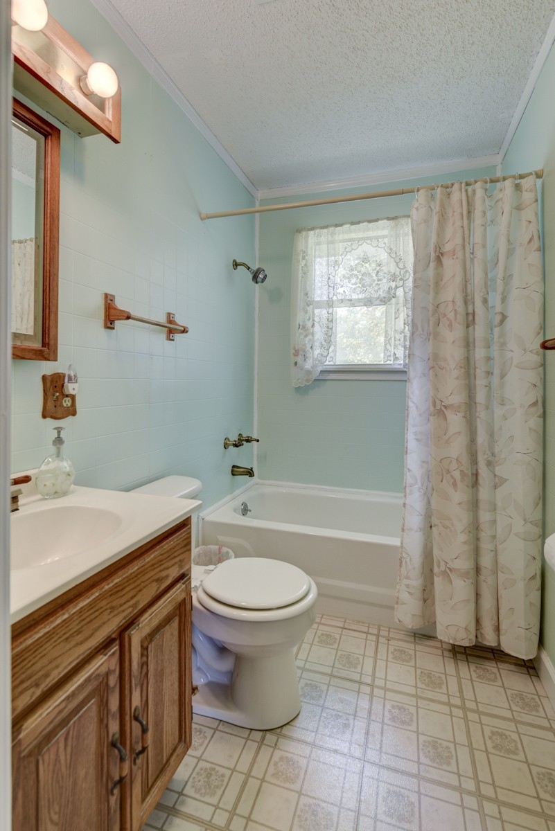 3945 Mitchell Road Lebanon, TN 37087 - Photo 30 of 41 a bathroom with a granite countertop sink a toilet and bathtub