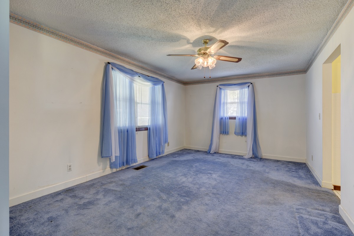 3945 Mitchell Road Lebanon, TN 37087 - Photo 33 of 41 an empty room with chandelier fan and windows