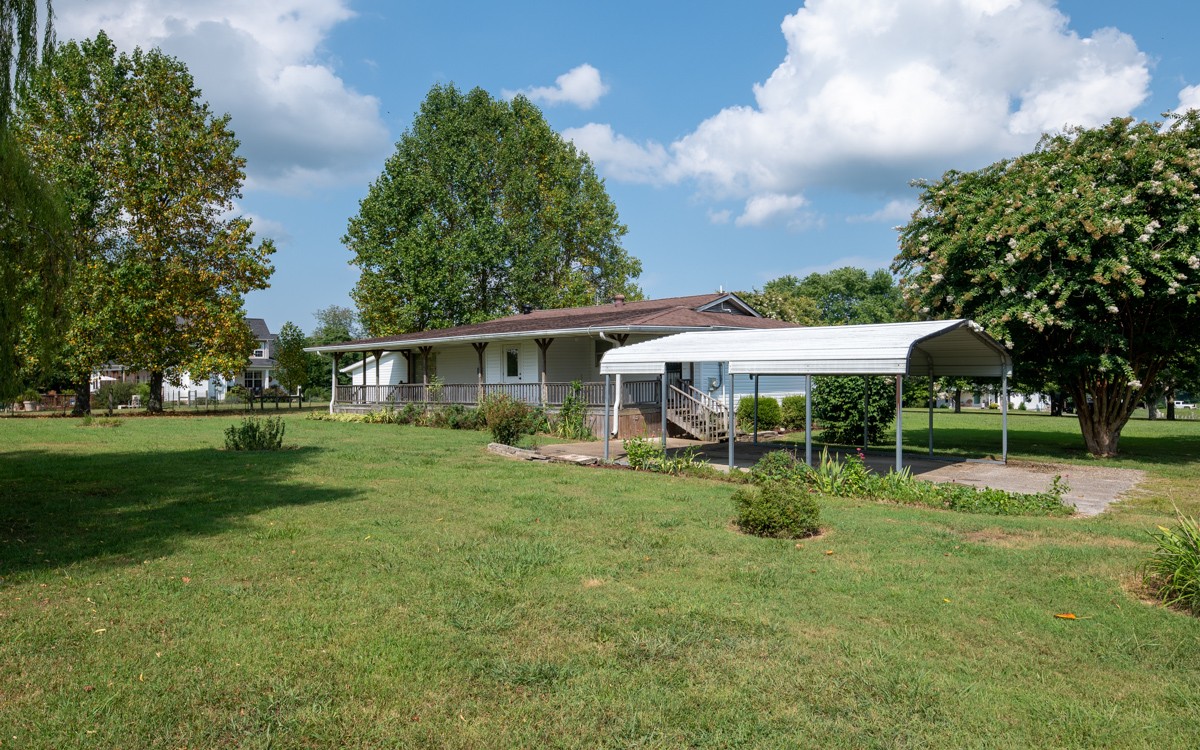 3945 Mitchell Road Lebanon, TN 37087 - Photo 8 of 41 a backyard of a house with table and chairs plants and large tree