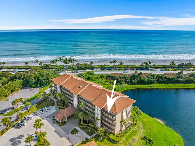a view of a lake with a table and chairs in roof deck