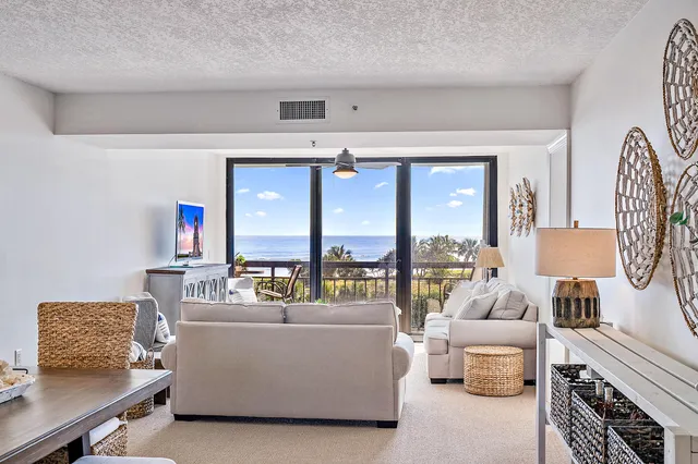 a living room with furniture and large windows