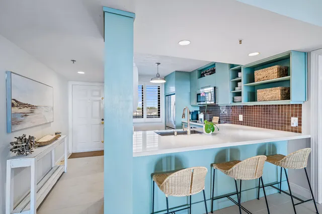 a dining room with kitchen island a table and chairs