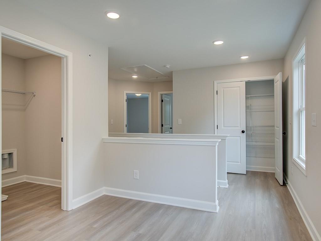 341 Colsen Drive Acworth, GA 30102 - Photo 21 of 36 wooden floor in an empty room with a kitchen