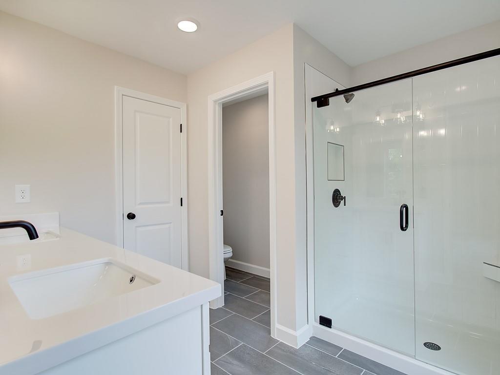 341 Colsen Drive Acworth, GA 30102 - Photo 4 of 36 a bathroom with a bathtub a shower a sink and a mirror