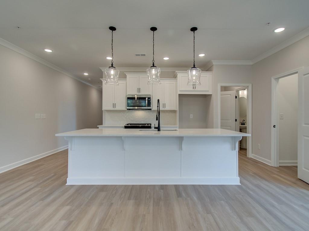 341 Colsen Drive Acworth, GA 30102 - Photo 5 of 36 a view of kitchen with stainless steel appliances granite countertop cabinets and wooden floor