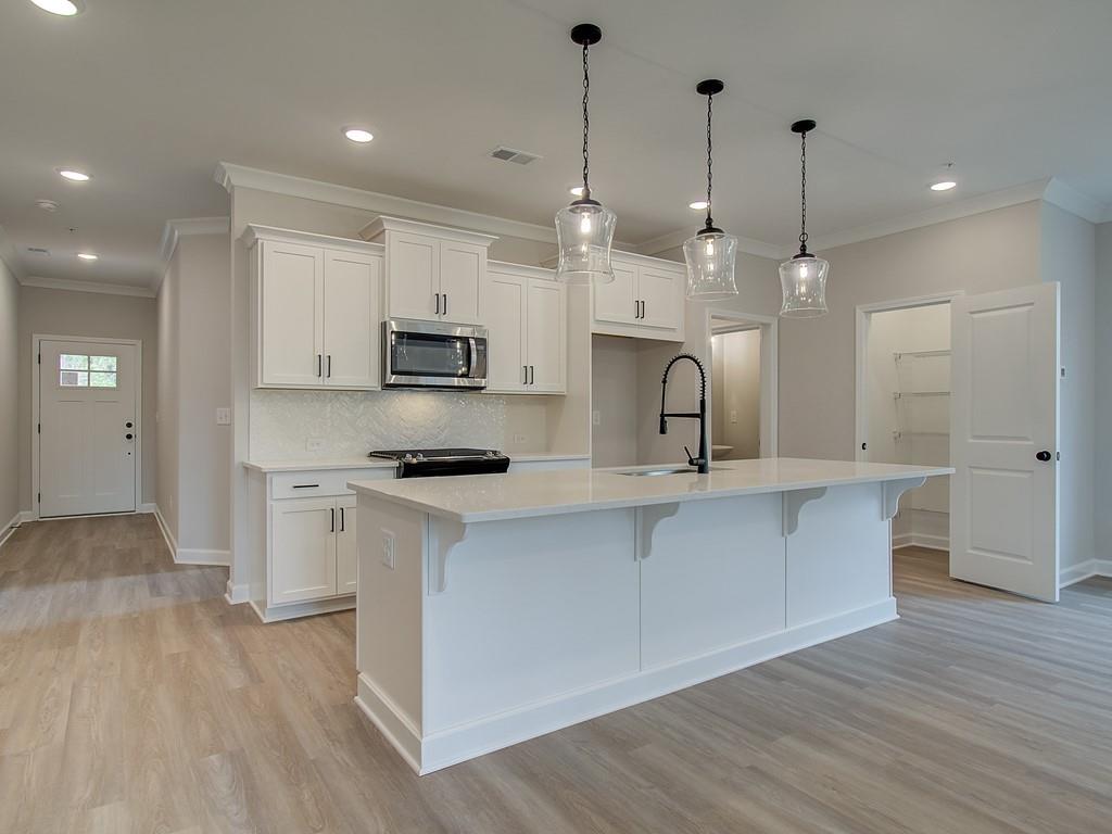 341 Colsen Drive Acworth, GA 30102 - Photo 10 of 36 a kitchen with kitchen island a sink stainless steel appliances and cabinets