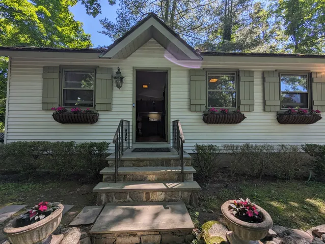 a front view of a house with garden